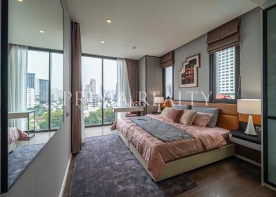 Modern bedroom with large windows and city view