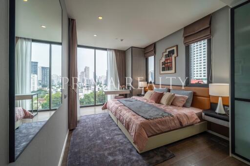 Modern bedroom with large windows and city view