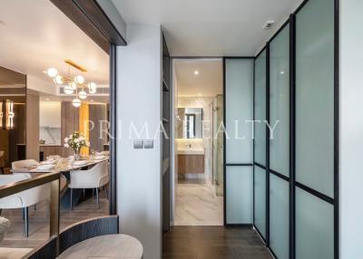 Modern dining area with open-plan layout leading to a corridor