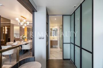 Modern dining area with open-plan layout leading to a corridor