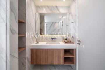 Modern bathroom with marble walls and wooden vanity