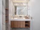 Modern bathroom with marble walls and wooden vanity