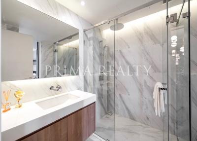 Modern bathroom with marble tiles and glass shower enclosure