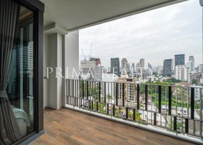 Spacious balcony with cityscape view and wooden floor