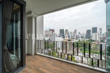 Spacious balcony with cityscape view and wooden floor