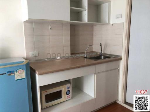 Compact kitchen space with modern appliances and wooden countertops