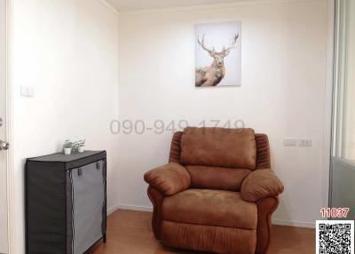 Cozy living room with a single brown recliner and deer artwork