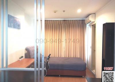 Modern bedroom with glass partition, a double bed, and exercise bike