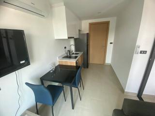 Modern kitchen with dining area and mounted television