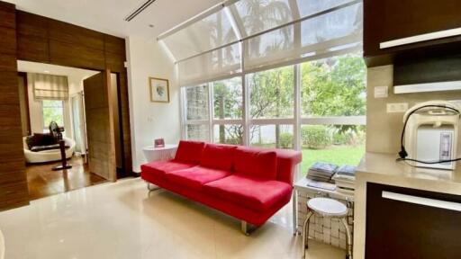 Modern living room with large windows and red sofa