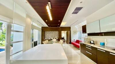 Modern kitchen with center island and open layout leading to the living area