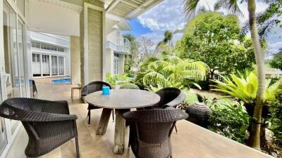 Spacious patio area with outdoor furniture and lush garden view