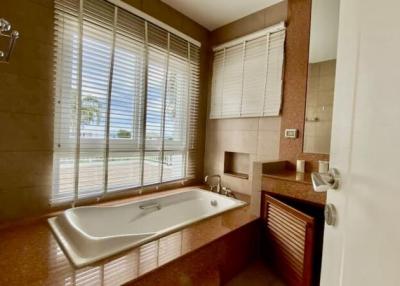 Spacious bathroom with large window and bathtub