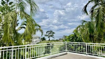 Spacious balcony with a scenic view of greenery and a clear sky