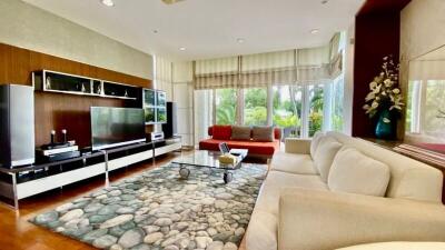 Spacious and modern living room with natural stone flooring and large windows