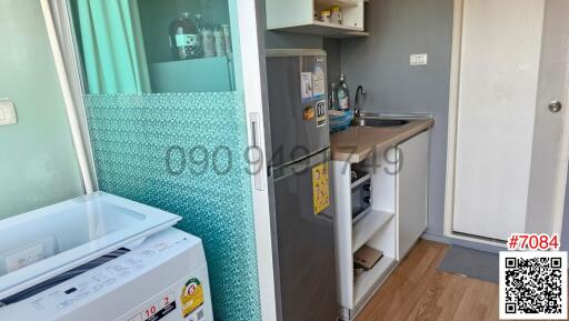 Compact kitchen with appliances and mosaic tile backsplash