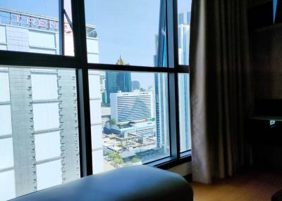 Bright bedroom with a city view and large windows