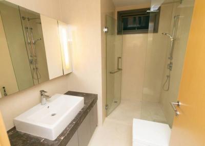 Modern bathroom with a glass shower booth and large mirror