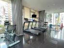 Modern gym with exercise equipment in residential building