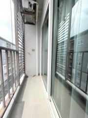 Narrow high-rise apartment balcony with large glass windows