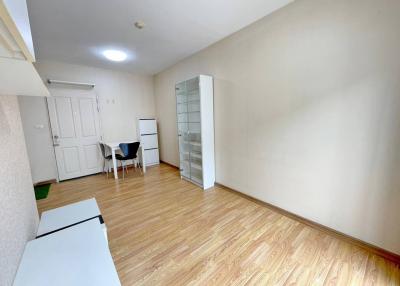 Spacious interior view of a well-lit room with hardwood flooring