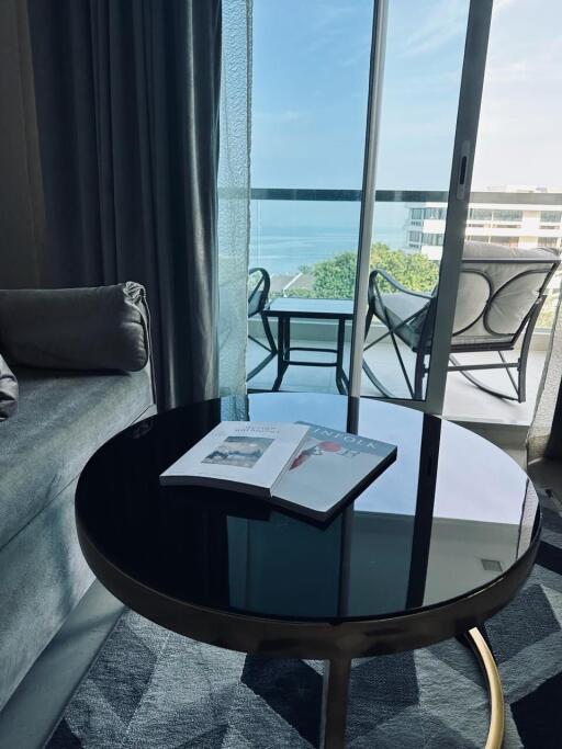 Modern living room with a view of the ocean through floor-to-ceiling glass doors