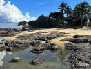 Serene beachfront with rocky shores and lush greenery