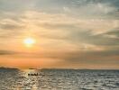 Serene beach sunset with boat on the water