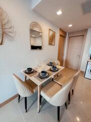 Modern dining area with a table set for four and decorative elements