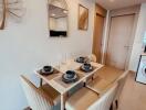 Modern dining area with a table set for four and decorative elements