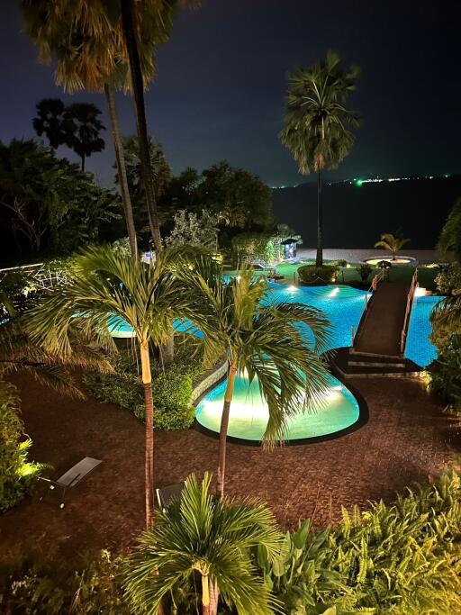 Luxurious poolside with tropical landscaping at night