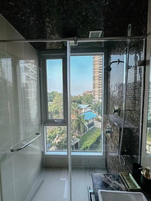 Modern bathroom with large window and natural views