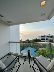 Cozy balcony with seating overlooking the ocean and sunset