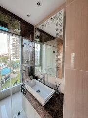 Modern bathroom with natural light and city view