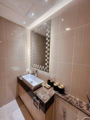 Modern bathroom with decorative mirror and marble countertop