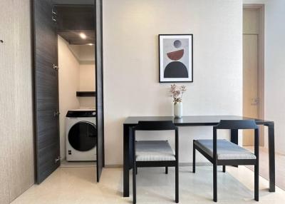 Modern dining area with adjacent laundry facilities