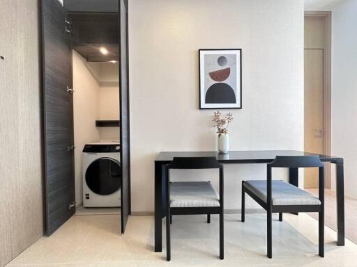 Modern dining area with adjacent laundry facilities