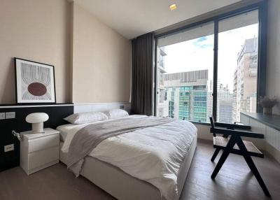 Modern bedroom with large windows and city view