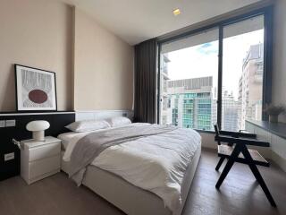 Modern bedroom with large windows and city view