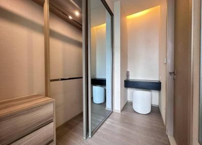 Modern bathroom with wooden cabinets and mirrored sliding door