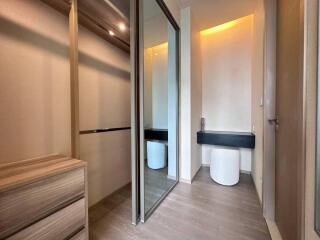 Modern bathroom with wooden cabinets and mirrored sliding door