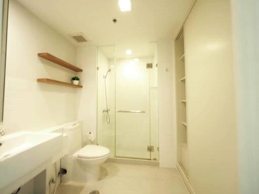 Modern bathroom interior with glass shower and white fixtures