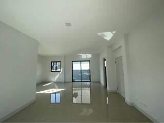 Spacious and bright empty living room with tiled flooring and large windows