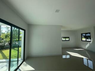 Spacious living room with large windows and natural light