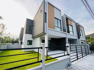 Modern residential home exterior with green lawn