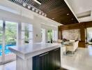 Modern kitchen with open plan dining area overlooking a pool