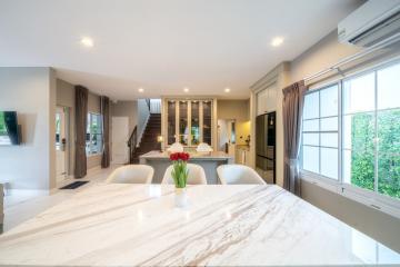 Bright and spacious kitchen with marble countertop and adjacent dining area