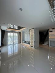 Spacious and Modern Interior with High Ceilings, Large Windows and Staircase