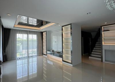 Spacious and Modern Interior with High Ceilings, Large Windows and Staircase