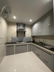 Modern kitchen with stainless steel appliances and gray cabinetry